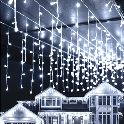 A house decorated with white icicle lights for Christmas.