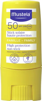 A yellow sunscreen stick with white and blue text and logos.