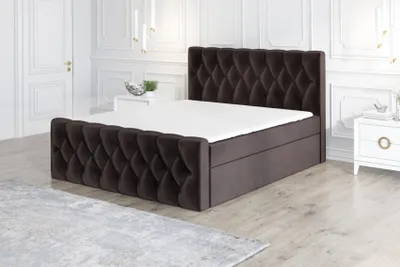 A bedroom with a bed and nightstand.