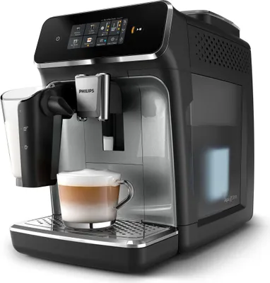 A black automatic coffee machine with a glass of latte on the drip tray.