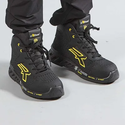 A pair of black and yellow U-Power safety high-top shoes.