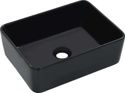 A black ceramic sink with a drain hole.