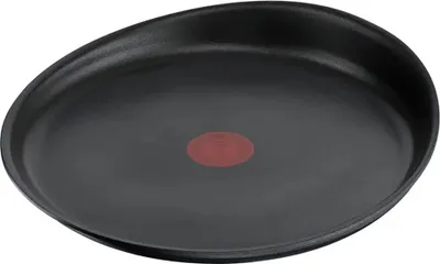 A black frying pan with a red indicator in the center, isolated on a white background.