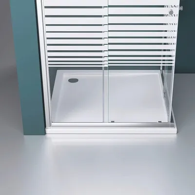 A close-up view of a modern shower enclosure with a sliding door and a white shower tray.