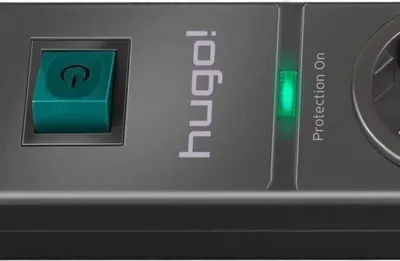 A close-up view of a black power strip with a green power button and a green indicator light.