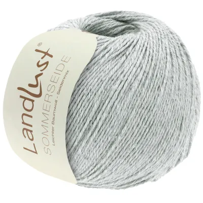 A ball of light gray yarn with a label.