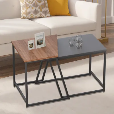 A living room setting with a white sofa and a set of nesting coffee tables.