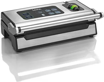 A vacuum sealing machine on a reflective white surface.