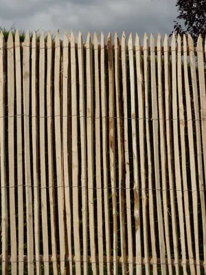 A close-up view of a wooden picket fence.