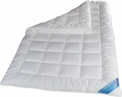 A white quilted duvet is shown laid out on a white background.