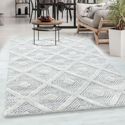 A living room scene with a rug, coffee table, and sofa.