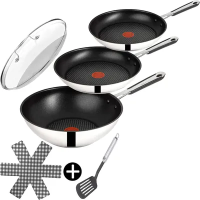 A set of cookware including frying pans, a wok, and a lid, along with a spatula and a pot holder.
