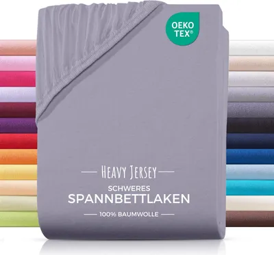 A folded grey fitted sheet is shown, with a stack of other colored sheets visible on the left and right sides.