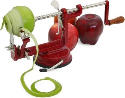 A red apple peeler is shown in use, peeling a green apple. Several red apples are visible in the background.