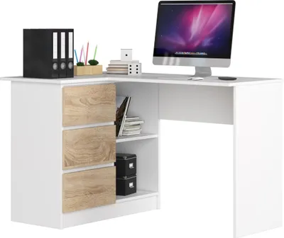 A white corner desk with wood-effect drawers and shelves, featuring a computer monitor and office supplies.