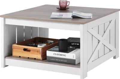 A square coffee table with a rustic farmhouse style, featuring an open shelf and a wooden tray with items inside.