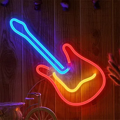 A neon LED light shaped like a guitar, mounted on a wooden wall.