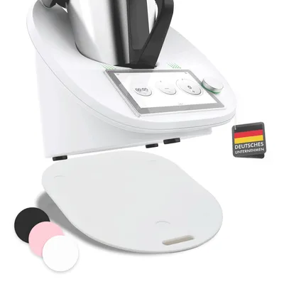 A white kitchen appliance with a touchscreen display and a white accessory underneath. Several colored circles are shown in the bottom left corner.