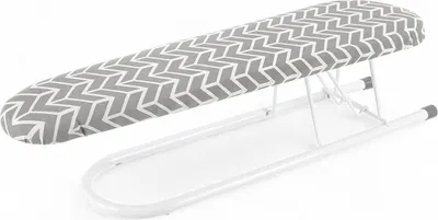 A tabletop ironing board with a gray and white geometric pattern on a white background.