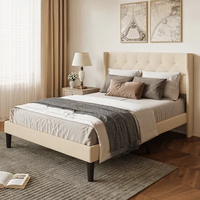 A bedroom scene with a bed, nightstand, lamp, and curtains.