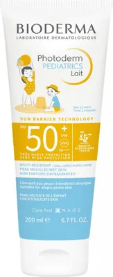 A tube of Bioderma Photoderm Pediatrics Lait sunscreen with illustrations of children playing on a beach.