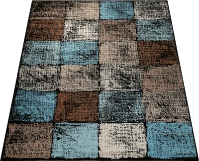 A rug with a checkered pattern of brown, blue, and cream squares.