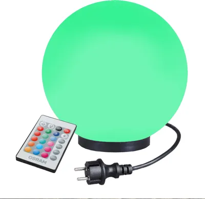 A spherical lamp with a remote control and a power plug.