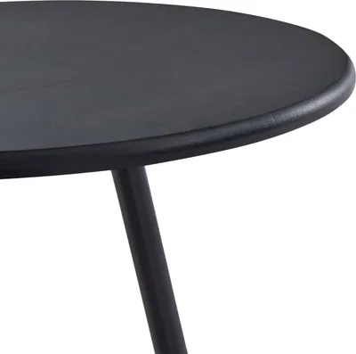 A close-up view of a black round table with one leg visible.