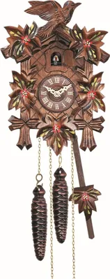 A cuckoo clock with decorative carvings and pinecone weights.