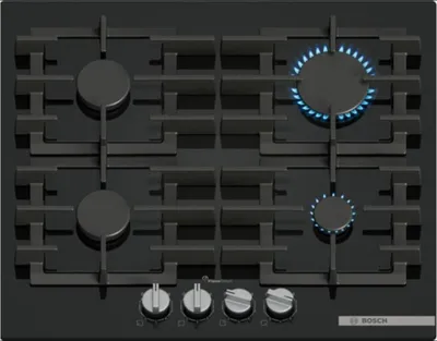 A top-down view of a black gas stovetop with four burners, two of which are lit with blue flames.