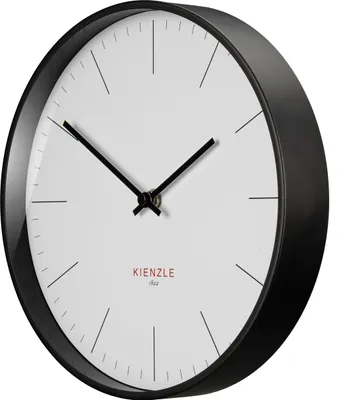 A close-up, angled view of a modern, minimalist wall clock with a black frame and a white face.