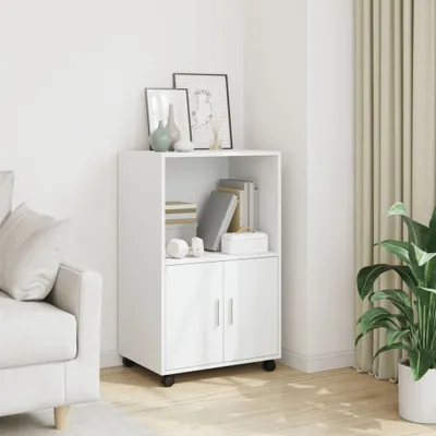A white cabinet with two doors and an open shelf, decorated with books and vases, placed in a room with a sofa and curtains.