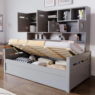 A grey wooden daybed with storage and shelving unit, shown with the bed frame lifted to reveal storage space.