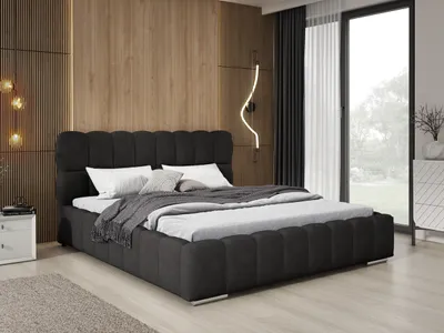 A modern bedroom with a large bed, wooden wall paneling, and a large window.
