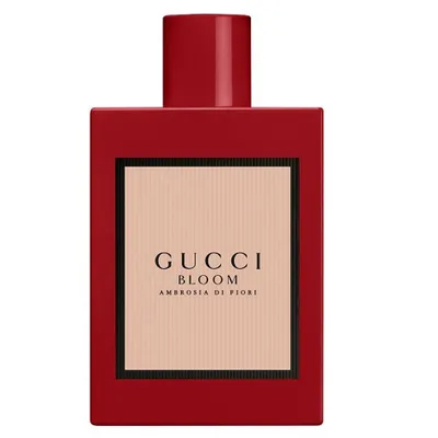 A product shot of a red Gucci perfume bottle.