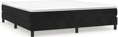 A black boxspring bed frame with a white mattress topper on a white background.