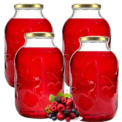 Four glass jars filled with red liquid, with a pile of berries in front of one jar.