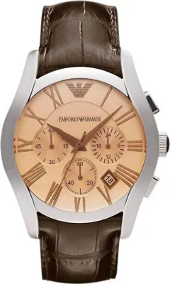 A close-up studio shot of an Emporio Armani men's chronograph watch with a brown leather strap and a gold-toned dial with Roman numerals.