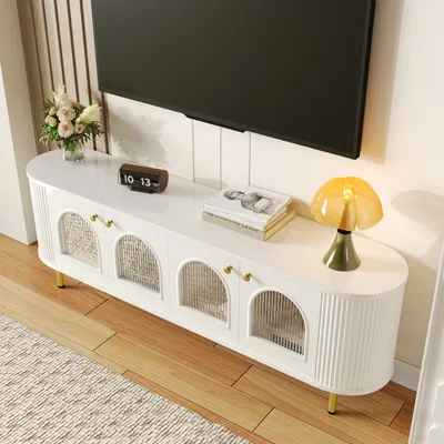 A white TV stand with gold accents is shown in a living room setting, with a TV mounted above it.