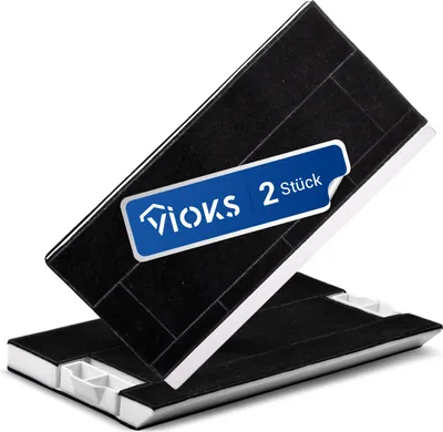 Two black carbon filters are stacked on a white background, with a blue label on the top filter.