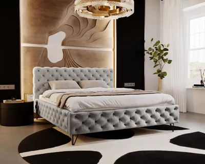 A luxurious bedroom with a tufted gray bed as the focal point.