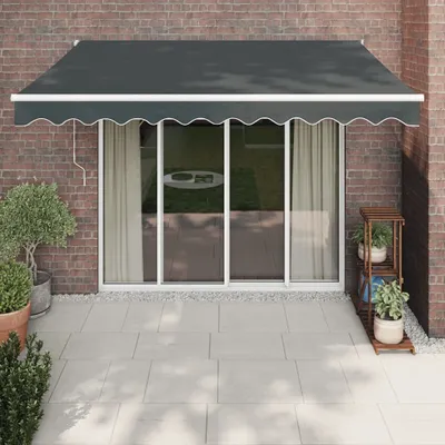 An awning is installed above a glass sliding door on a brick wall.