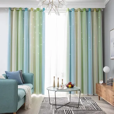 A living room scene with a sofa, coffee table, rug, and curtains.