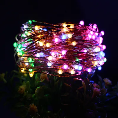 A close-up shot of a coiled string of colorful LED lights.