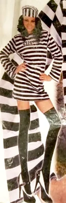 A woman in a prisoner costume posing.