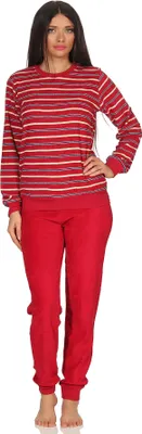 A woman is standing and modeling a red and white striped pajama set.