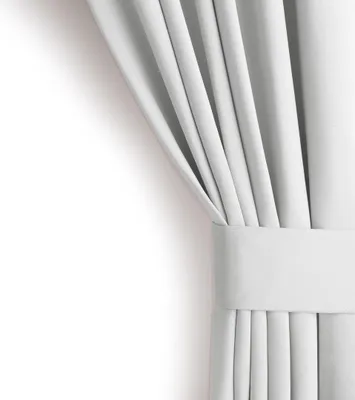 A close-up view of a white curtain, neatly folded and held by a fabric band.