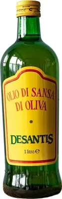 A bottle of olive oil against a white background.