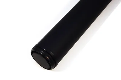 A close-up shot of the end of a black cylindrical object, likely a table leg, on a white background.