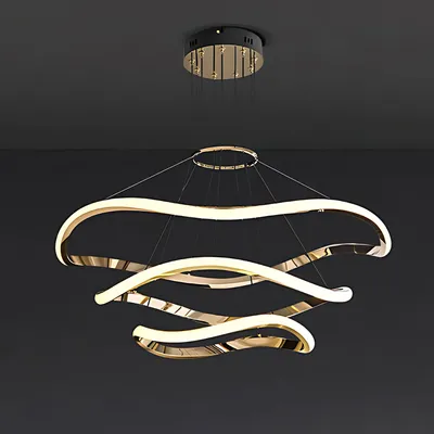 A modern, multi-tiered gold and white chandelier hanging from a dark ceiling.